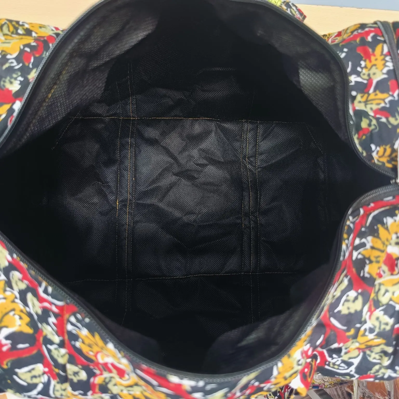 Expandable Travel Bag  Black with Mustered Flower Design.